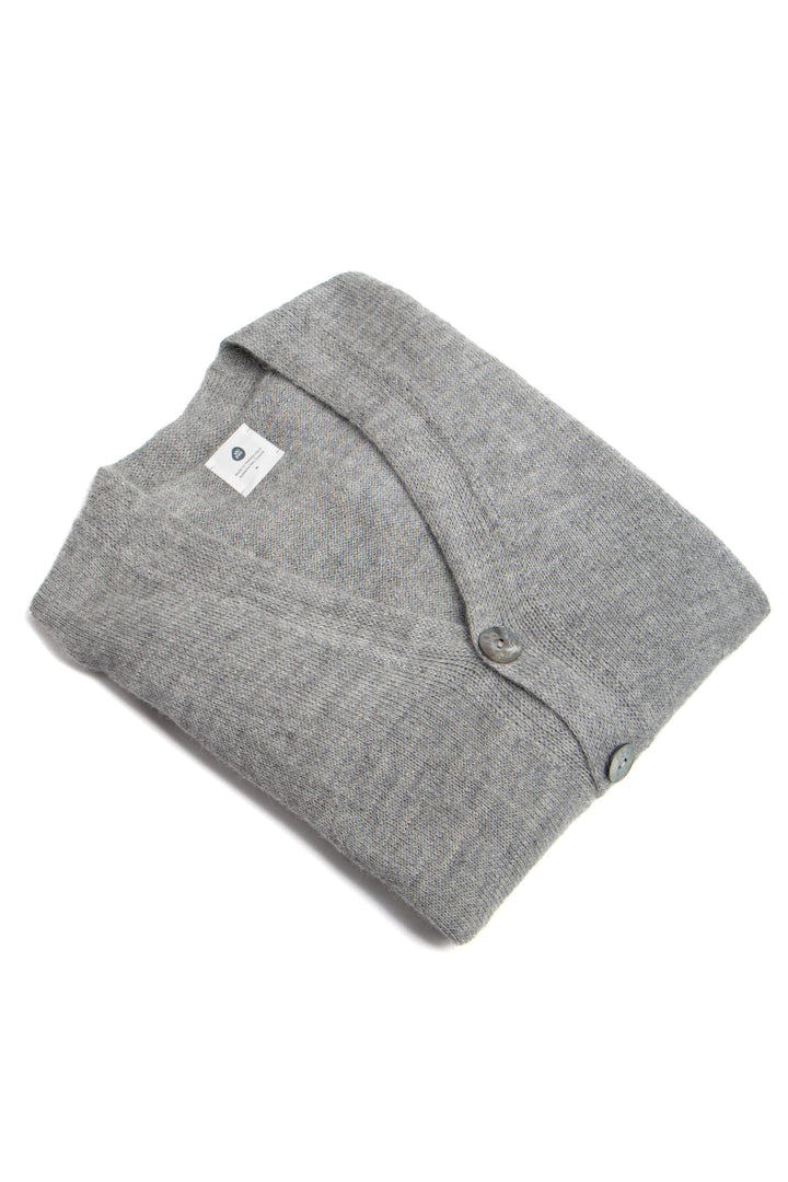 Folded gray sweater with a brand label on a white background #colour_cool-grey