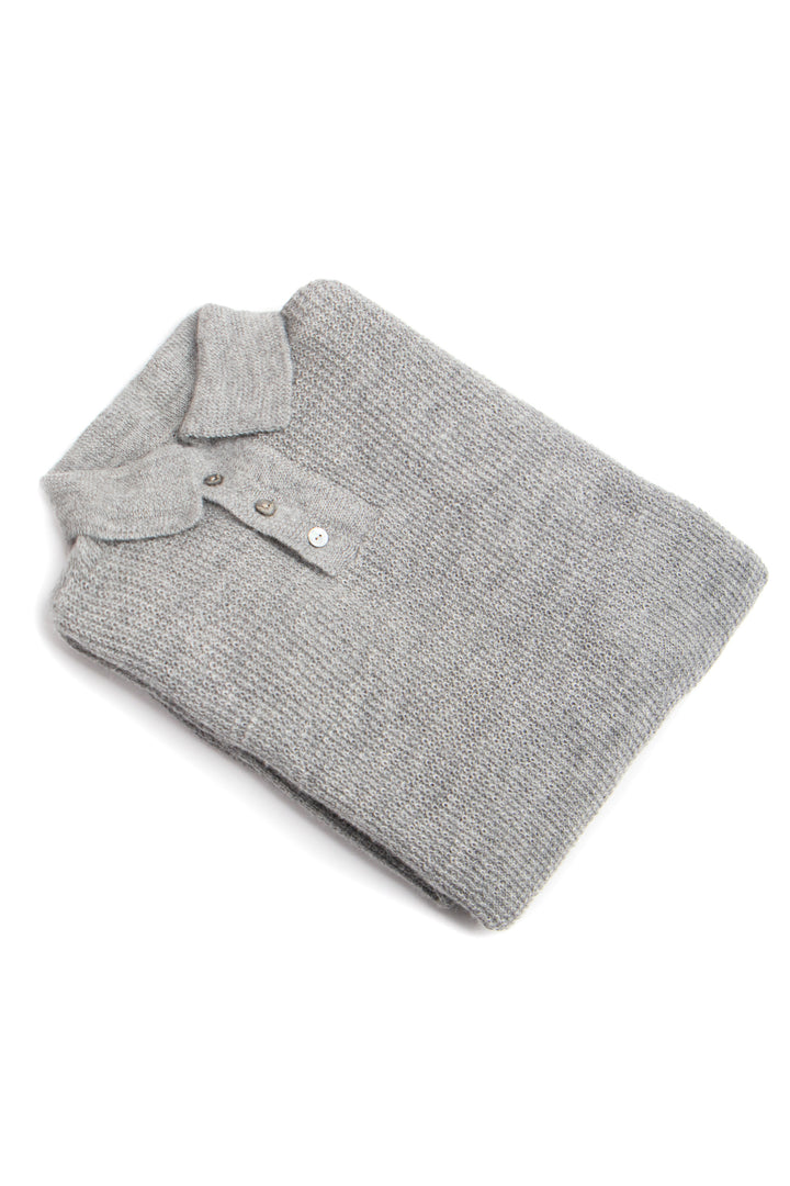 Folded gray polo shirt on a white background #colour_cool-grey