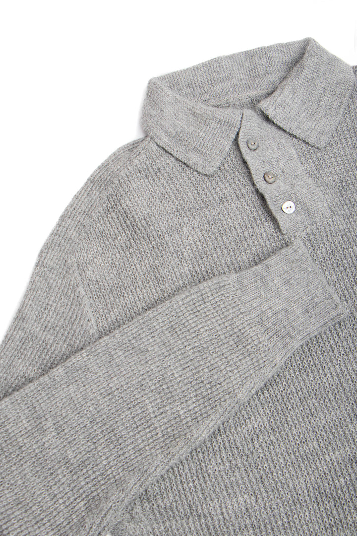 Close-up of a gray knitted sweater with a collar and buttons on a white background #colour_cool-grey
