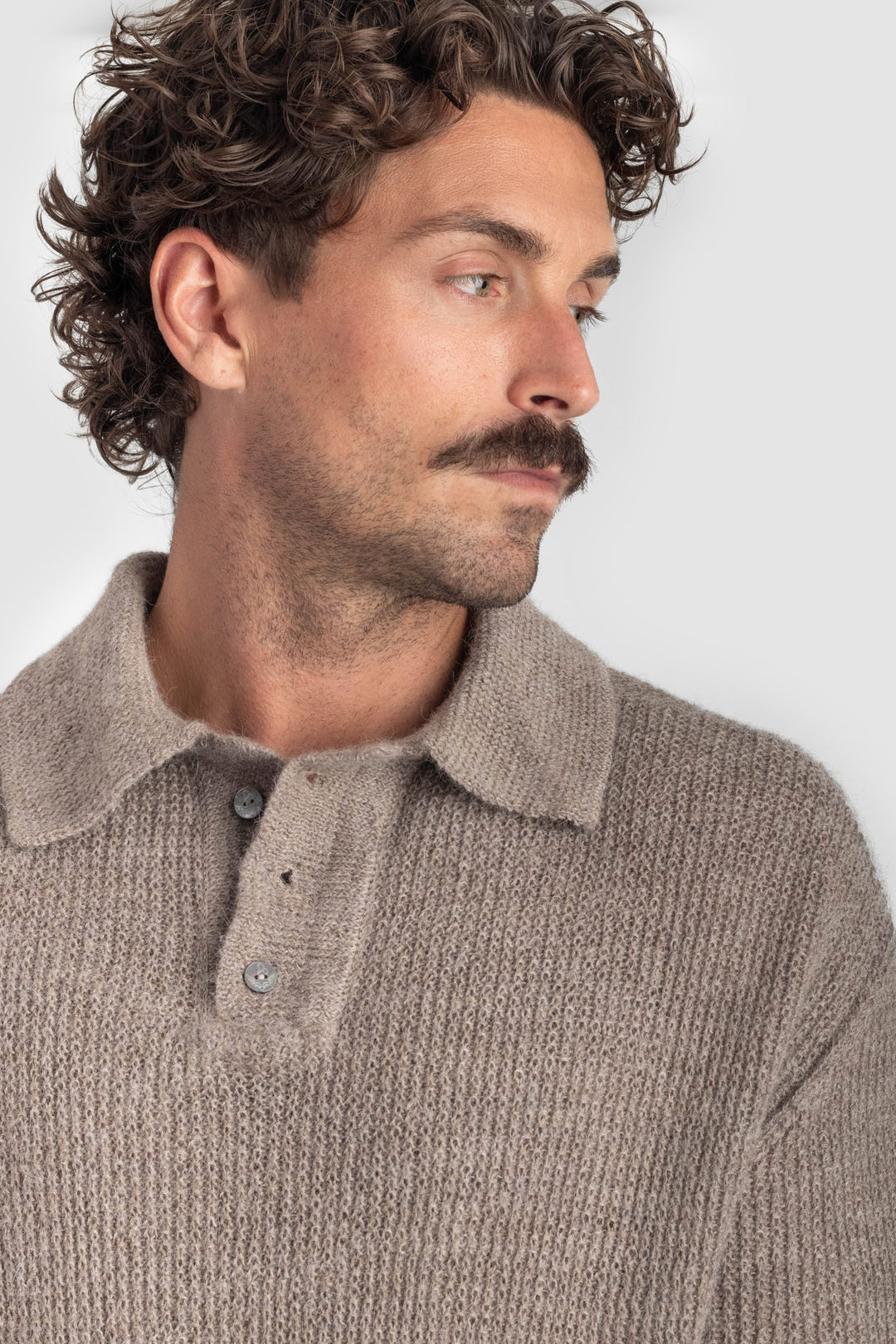 Man wearing a brown knitted sweater against a white background #colour_fawn