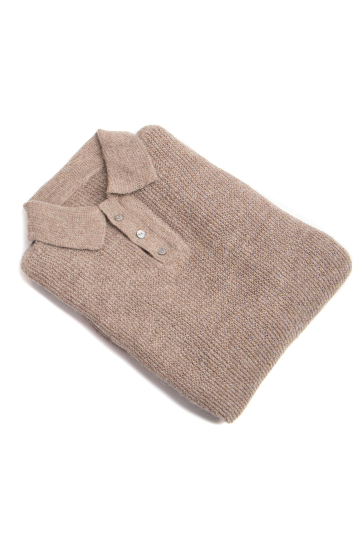 Folded beige polo shirt on a white background #colour_fawn